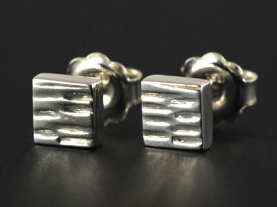 Handmade chunky square stud earrings in sterling silver with a barked effect finish.
